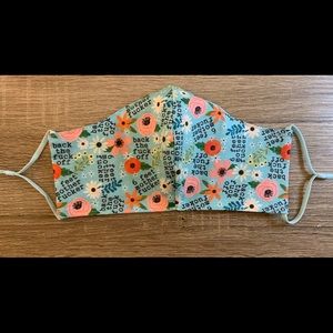 Fitted flowery profanity mask with nose wire ear loops and corded elastic ties